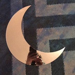 Moon shaped wall mirror